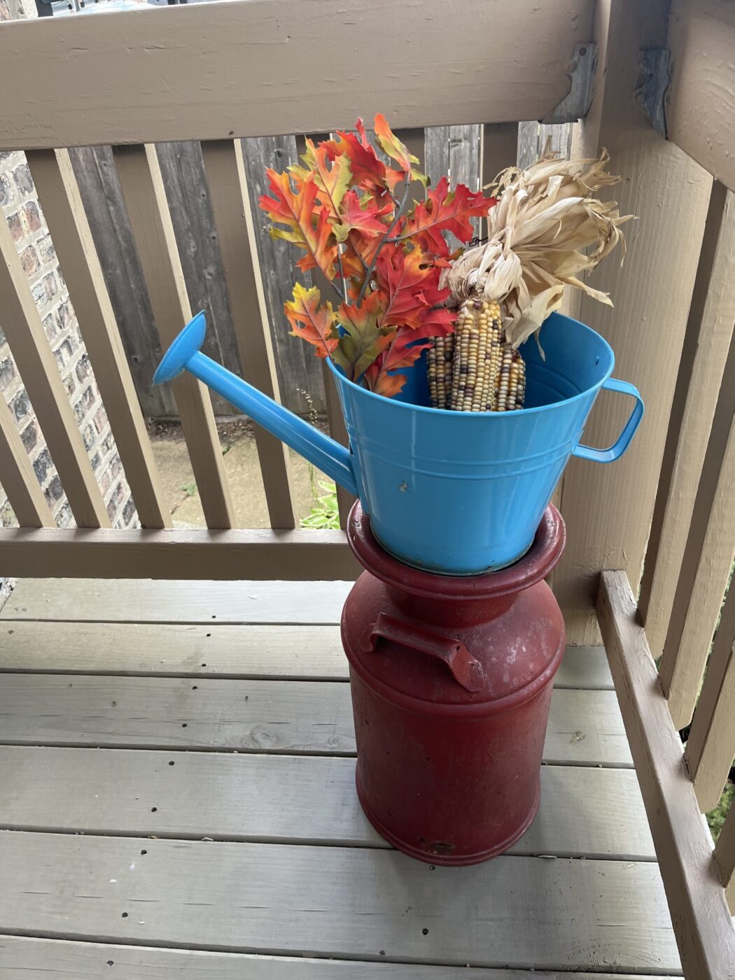 Blue Watering Can with Corn and Leaves